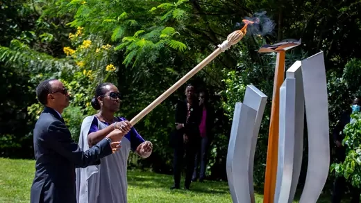 President Paul Kagame and First Lady Jeanette Kagame light the Rwandan genocide flame of hope, known as the "Kwibuka" (Remembering), to commemorate the 1994 Genocide at the Kigali Genocide Memorial Center in Kigali, Rwanda, on April 7, 2020. They are flanked by greener as they both old a long and lit torch that lights the memorial.