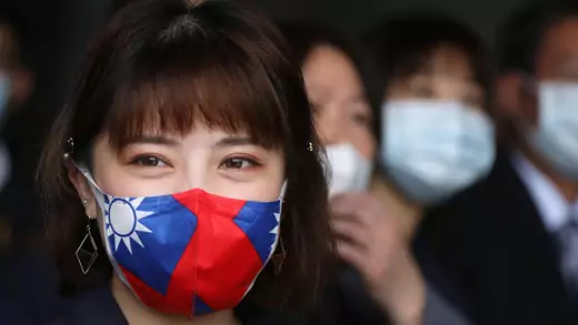 A woman wears a face mask with the Taiwan flag on it.