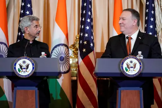 S. Jaishankar and Mike Pompeo at a press briefing, looking toward each other