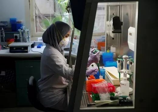 A lab technician prepares a medium to grow a virus at the Eijkman Institute, one of the only two facilities in Indonesia capable of diagnosing Zika, in Jakarta, Indonesia.