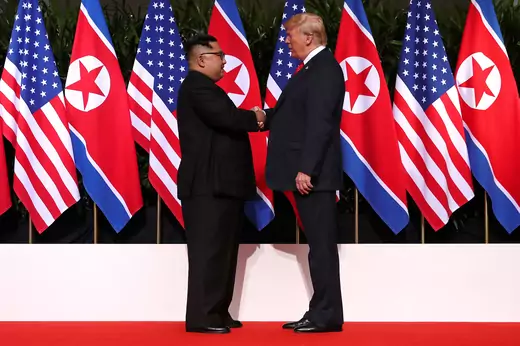 Trump and Kim shaking hands.