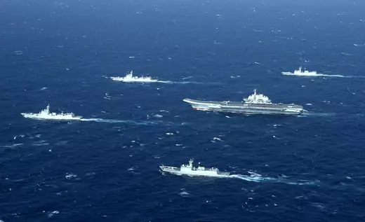 This aerial photo taken on January 2, 2017 shows a Chinese navy formation, including the aircraft carrier Liaoning (C), during military drills in the South China Sea. The aircraft carrier is one of the latest steps in the years-long build-up of China's military, as Beijing seeks greater global power to match its economic might and asserts itself more aggressively in its own backyard.