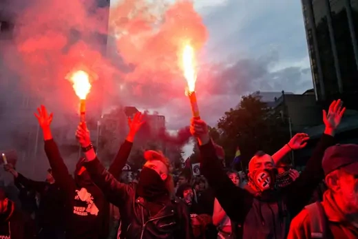 Left wing protesters with flares during a demonstration against far right group "Hogar Social" and their new occupied building.