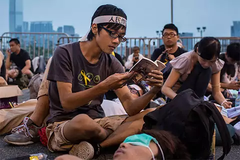 Hong Kong protester reads book while sitting