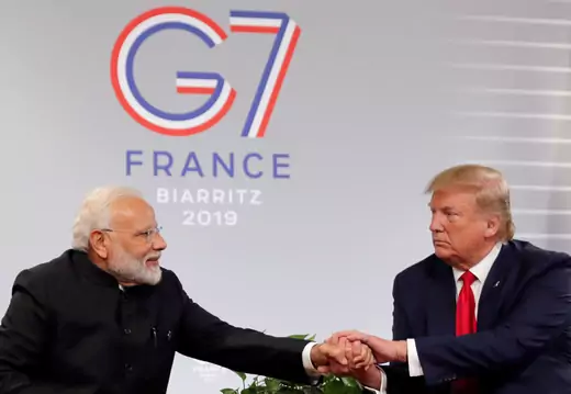 Donald Trump and Narendra Modi shaking hands at G7