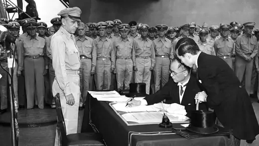 Japanese delegates sign the formal surrender on behalf of the imperial Japanese government onboard the USS Missouri in Tokyo Bay.