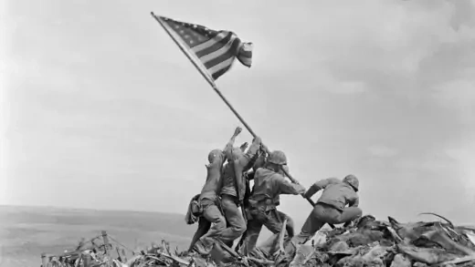 U.S. Marines raise a U.S. flag atop Mount Suribachi, Iwo Jima. 