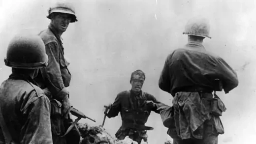 A Japanese officer surrenders to U.S. armed forces.