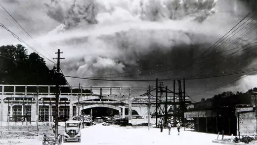 A mushroom cloud from the atomic bomb rises over Nagasaki.