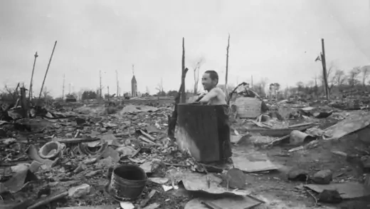 A man bathes amid the rubble of Tokyo. 