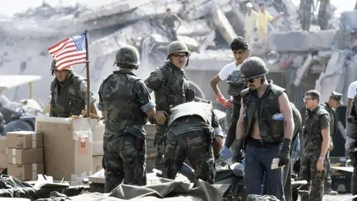 A group of American soldiers stands amid the debris of the U.S. embassy in Beirut