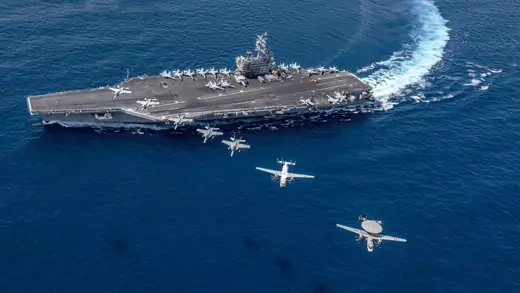 U.S. military aircraft fly over the USS Ronald Reagan in the South China Sea. 