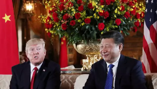U.S. President Donald Trump sits left of Chinese President Xi Jinping.