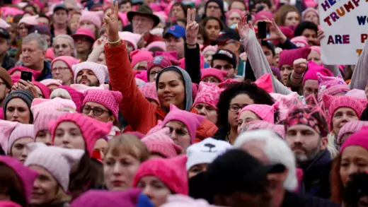 Women wear pink hats as they participate in the 2017 Women's March.