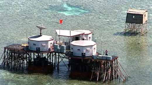An April 1995 aerial photo shows a manned outpost equipped with a Chinese-built satellite dish in Mischief Reef.