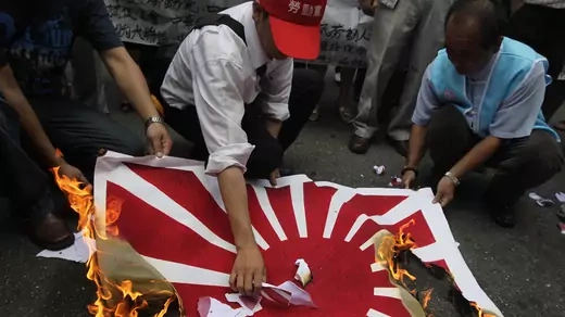 Activists in Taipei burn a flag symbolizing Japan during a protest over the Chinese fishing boat captain's detainment. 