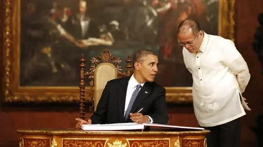 U.S. President Barack Obama talks with Philippine President Benigno Aquino in Manila. 
