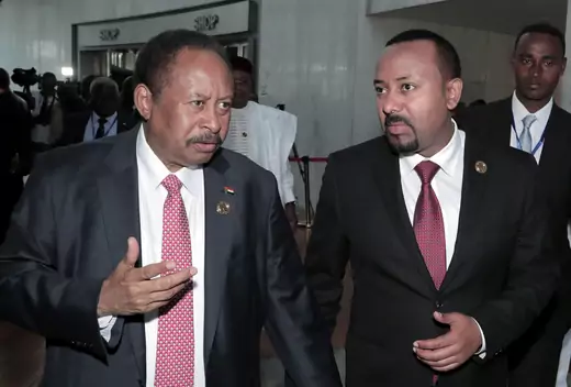 Sudan's Prime Minister Abdalla Hamdok and Ethiopia's Prime Minister Abiy Ahmed arrive for the opening of the 33rd Ordinary Session of the Assembly of the Heads of State and the Government of the African Union (AU) in Addis Ababa, Ethiopia, February 9, 2020.