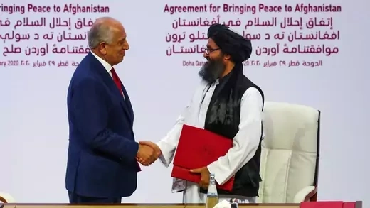 Mullah Abdul Ghani Baradar, the leader of the Taliban delegation, and Zalmay Khalilzad, U.S. envoy for peace in Afghanistan, shake hands after signing an agreement at a ceremony between members of Afghanistan's Taliban and the United States in Doha, Qatar on February 29, 2020.