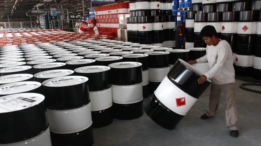 An employee of Petron Corp, the Philippines' largest oil refiner, prepares empty fuel drums.