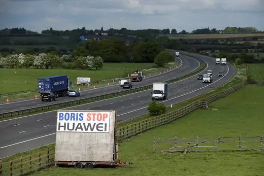 A sign reading "Boris Stop Huawei" is seen next to the M40 motorway.