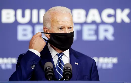 Democratic U.S. presidential candidate and former Vice President Joe Biden adjusts his protective face mask as he speaks about his economic recovery plan to revive the coronavirus-battered U.S. economy during a campaign event in New Castle, Delaware, U.S.