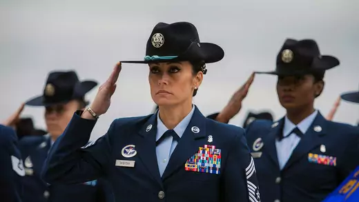Women serving in the United States Air Force stand in salute.