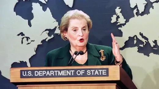 Madeleine Albright gives a speech from behind a lectern at the U.S. State Department
