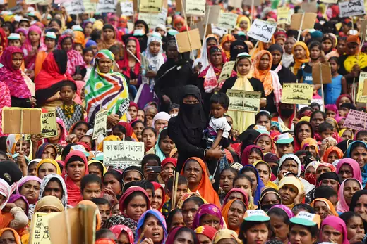 Muslim women in India hold signs during a protest against the Citizenship Amendment Act. 