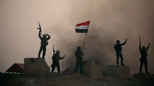 Members of the paramilitary Popular Mobilization Forces take part in their graduation ceremony at a military camp in Kerbala.