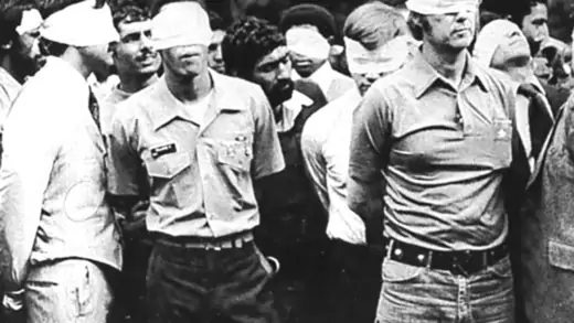 Blindfolded U.S. hostages and their Iranian captors outside the U.S. embassy in Tehran, Iran, 1979.