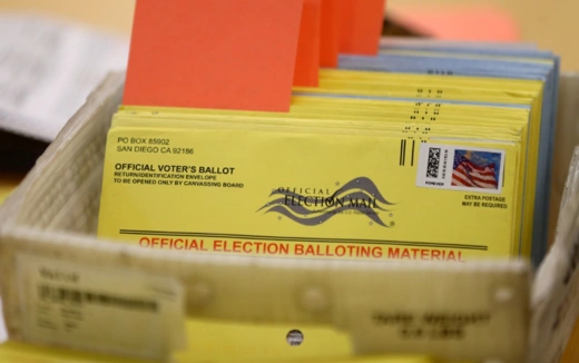 Mail-in ballots sit in a box before they are verified by election officials in 2016. 