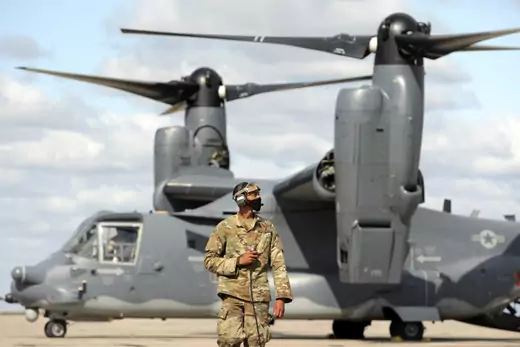 A serviceman of the U.S. Air Force stands in front of a Bell V-22 Osprey tiltrotor during the joint military drills of the Special Operations Forces (SOF) of the Ukrainian Armed Forces and the US Army Europe.