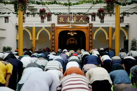 People kneel and pray in a mosque in Shanghai, China.