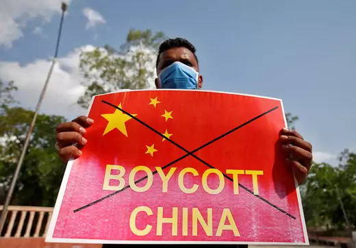 A member of National Students' Union of India (NSUI) holds a placard during a protest against China.