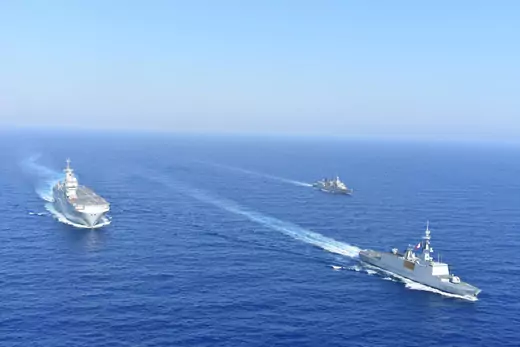 Three Greek and French military vessels sail in formation in the Mediterraneans Sea.