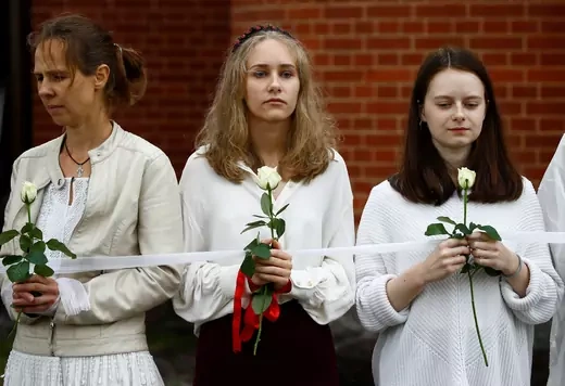 Women holding flowers at rally in Belarus