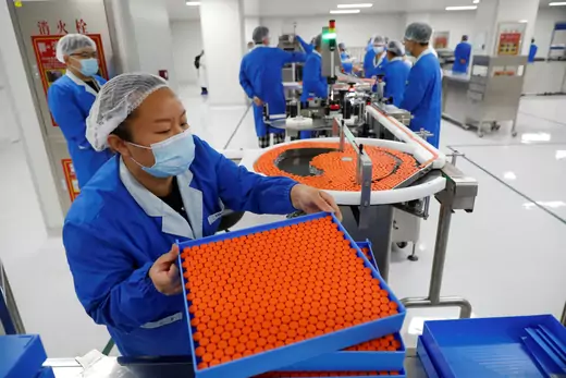 People work in the packaging facility of Chinese vaccine maker Sinovac Biotech, developing an experimental coronavirus disease (COVID-19) vaccine, during a government-organized media tour in Beijing, China.
