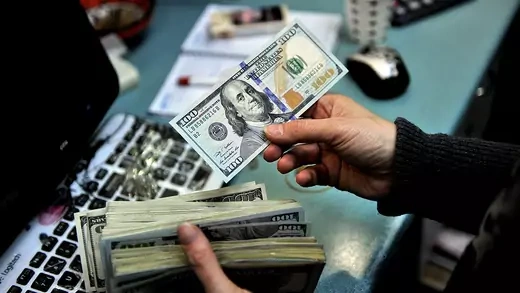 A man counts U.S. dollars at a market in Turkey