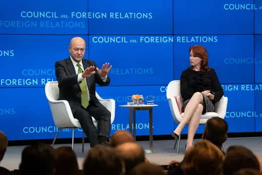Barham Salih and Meghan L. O'Sulivan sit on white chairs on stage in front of a blue CFR background