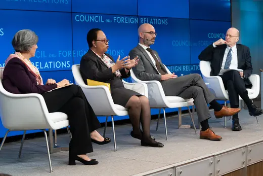 Four panelists sit on stage in white chairs against a blue Council on Foreign Relations backdrop