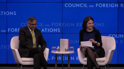 Two panelists, both in black, sit in white chairs in front of a blue CFR background