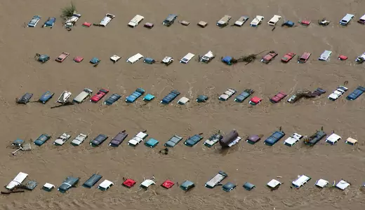 Muddy waters nearly submerge lines of cars during a flood in Colorado, United States. 