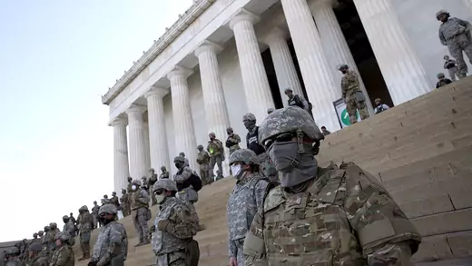 Members of the D.C. National Guard stand on the steps of the Lincoln Memorial.