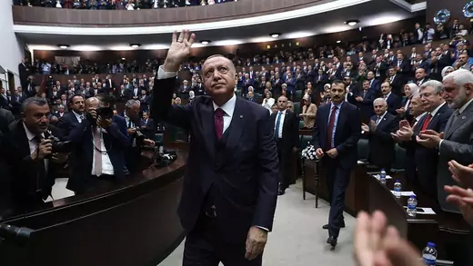  Turkish President Recep Tayyip Erdogan waves while surrounded by members of the Grand National Assembly of Turkey.