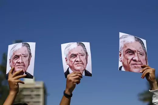 emonstrators display compositions made with pictures of Chilean President Sebastian Pinera (L) and late dictator Augusto Pinochet, during a march in Santiago, on the sixth straight day of street violence which erupted over a now suspended hike in metro ticket prices.