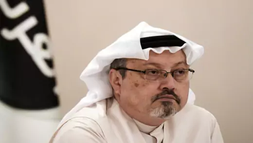 Jamal Khashoggi looks on during a press conference