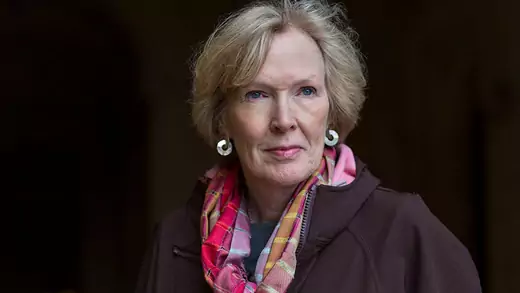 Image of Margaret MacMillan looking to her right, in a brown coat and pink scarf