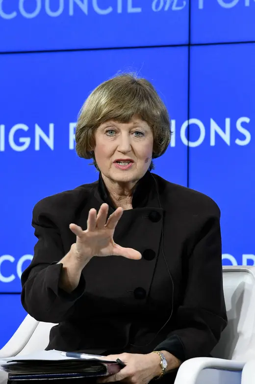 Jennifer Hillman, in black, sits in front of a blue CFR background