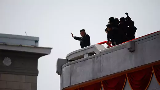 North Korean leader Kim Jong Un waves to people attending a military parade marking the 105th birth anniversary of country's founding father Kim Il Sung in Pyongyang, A